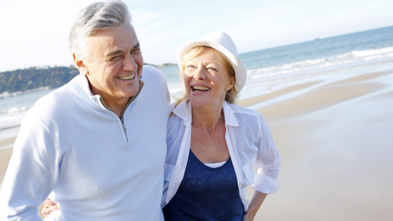 two older adults on a beach consider the best place to retire in north carolina