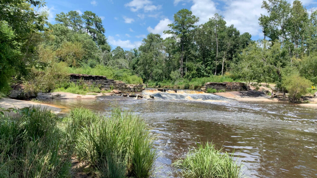 water cascades over rocks in little river park in Zebulon, NC.