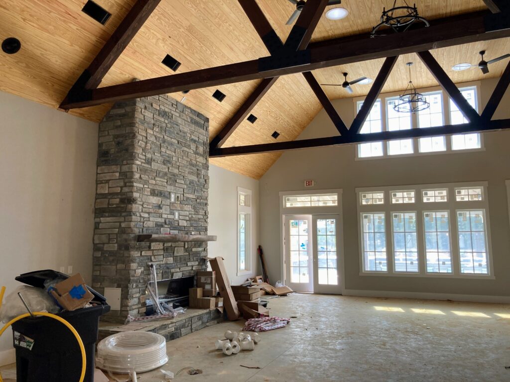 The clubhouse at Serenity boasts a great room with beams, vaults, and a stone fireplace.